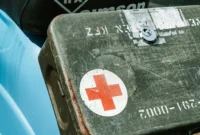 a close up of a motorcycle with a red cross on it